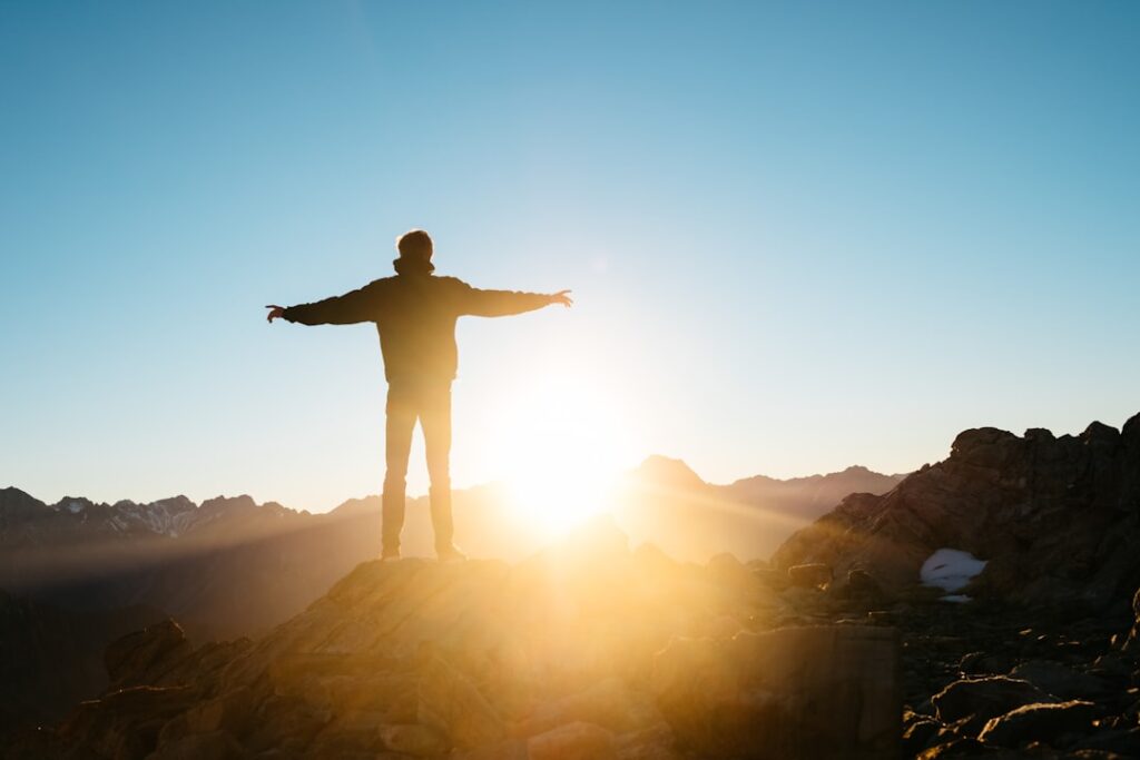 person standing on hill person standing on hill